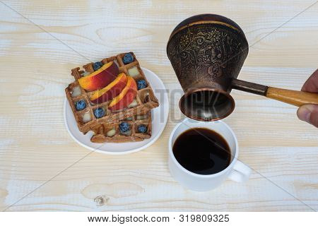 Chocolate Belgian Waffles With Fruits, Cup Of Coffee And Cezve On White Wooden Background. Delicious