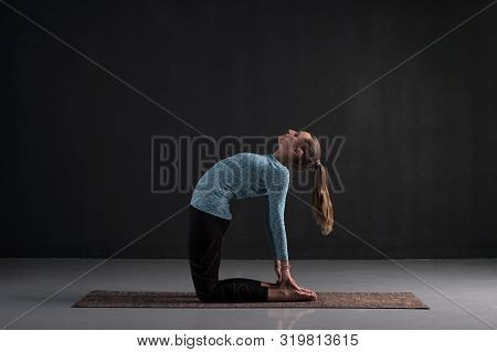 Woman Doing Stretching Exercise Camel Pose Or Ushtrasana.