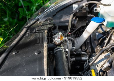 Hose Connecting The Car Radiator With The Engine, In The Background The Engine Compartment.