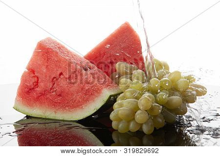 Pieces Of Watermelon And Bunch Of Grape On A Glass