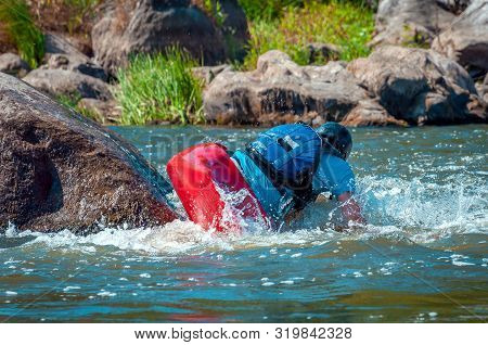 Playboating. A Man Sitting In A Kayak With Oars In His Hands Performs Exercises On The Water. Kayaki