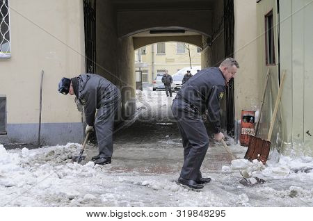 Saint Petersburg, Russia - February 07, 2010: Police Officers (police) Clear The Yard Of Snow