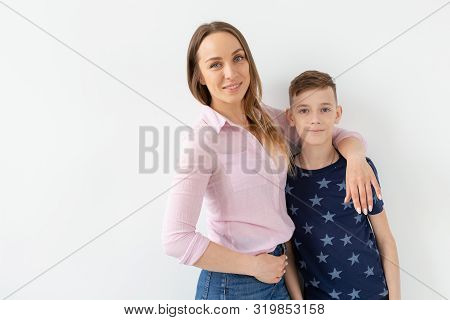 Good-looking Single-parent Mom And Teen Son On White Background. Cohesion, Friendship And Family Rel