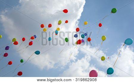 Many Colored Balloons Fly Into The Blue Sky With Many White Clouds In Summer During The Party