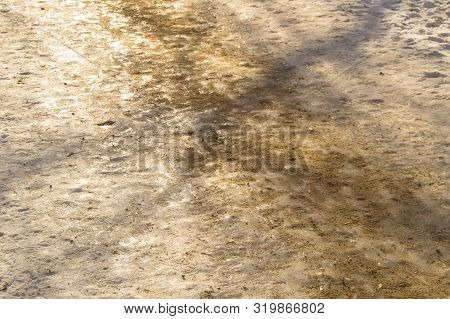 Slippery Winter Road, Sidewalk In The Park, Covered With Ice And Sprinkled With Sand. Anti-skid And 