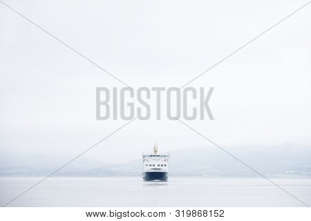 Ferry Ship On Sea In Middle Of Empty Horizon