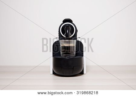 Coffee Espresso Capsule Machine Maker And Glass Against Plain Neutral Background