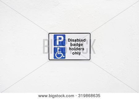 Disabled Badge Holders Only At Car Park Sign Post