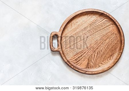 Empty Round Wooden Dish On Grey Concrete Background, Copy Space For Your Text
