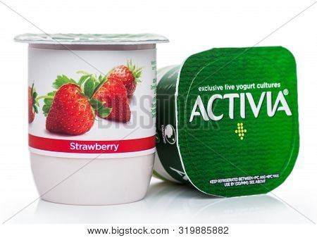 London, Uk - August 18, 2019: Cup Of Activia Exclusive Live Yogurt Cultures With Strawberries On Whi