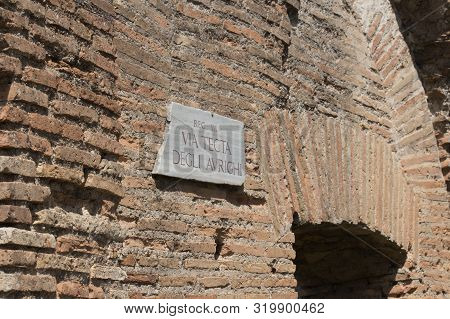Italy, Ostia - April 16 2017: The View Of Signpost On The Wall Of Via Tecta Degli Aurighi In The Anc