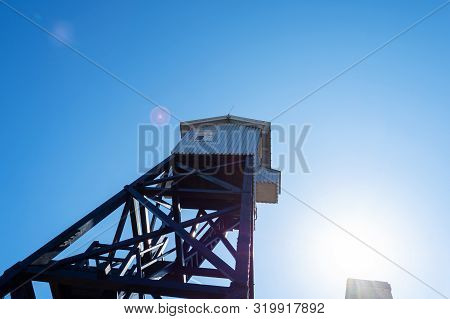 Wooden Observation Tower On A Background Of Blue Sky.