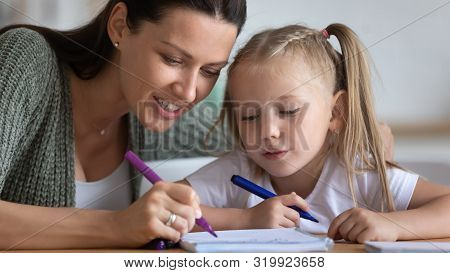 Painstaking Daughter And Mother Draw Together With Felt-tip Pens
