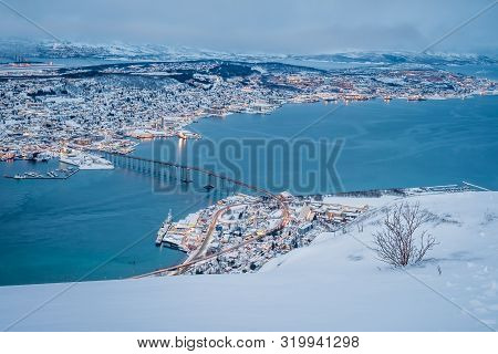 Aerial View To The City Of Tromso In Winter From The Mountain Ledge Storsteinen, 421 M Above Sea Lev
