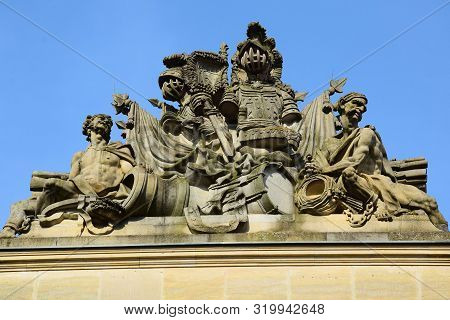 Sculpture Of Two Men With Weapons And Armor On The Roof Of The Building. Berlin. May 2018