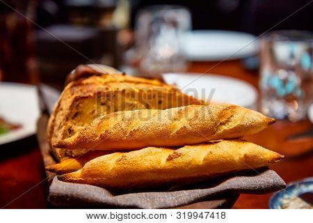 Basket With Different Bread On The Table In The Restaurant