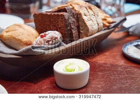 Basket With Different Bread On The Table In The Restaurant