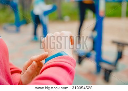 Girl Sport Uses Finger Touches Fitness Bracelet To Measure Heart Rate And Number Steps, Useful Techn