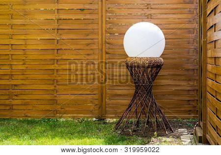 A White Sphere On A Wooden Stick Hyperboloid Support Structure In The Right Side Of The Image In Fro