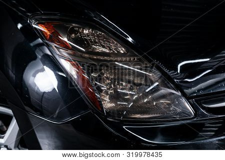 Novosibirsk, Russia - August 19, 2019: Toyota Prius, Black Car Headlights. Exterior Detail. Close Up
