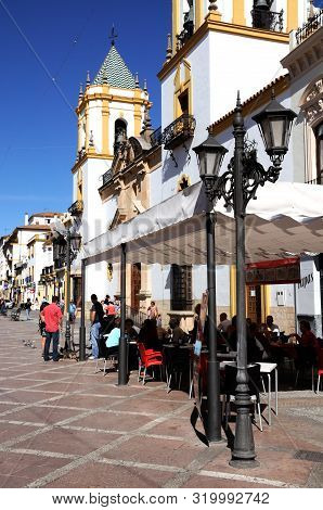 Ronda, Spain - October 24, 2009 - Tourists Relaxing At Pavement Cafes In The Plaza Socorro With The 