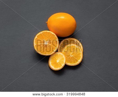 Sliced Citrus Fruit On A Stone Table. Food Background. Flat Lay. Juicy Ripe Slices Of Orange Lemon, 