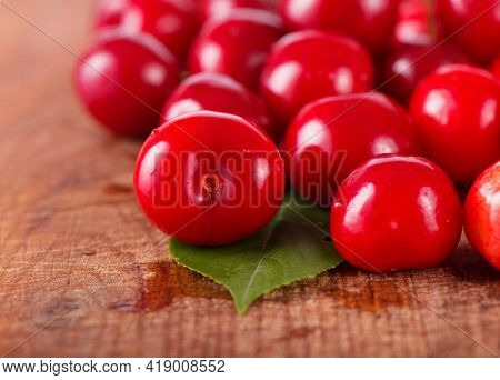 Cherries On Wooden Table With Water Drops Macro Background