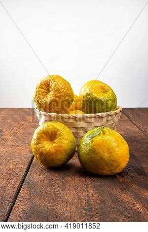 Orange Ponkan, Orange Ponkan In A Basket On Rustic Wooden Light Background, Selective Focus.