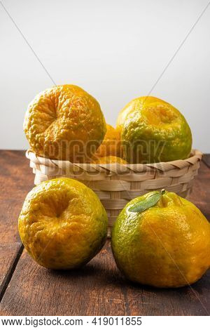 Orange Ponkan, Orange Ponkan In A Basket On Rustic Wooden Light Background, Selective Focus.
