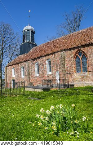 Fransum, Netherlands - April 20, 2021: Spring Flowers In Front Of The Church Of Fransum, Netherlands