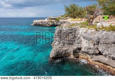 Caribbean Rocky Beach With Turquoise Water In Negril, Jamaica