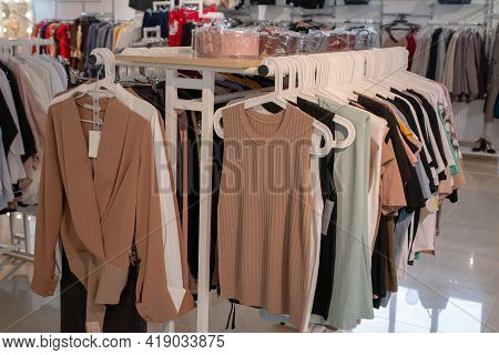 Stylish Collection Of Womens Clothing Hanging On Hangers In The Showroom. Copspace