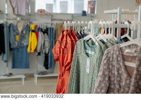 Stylish Collection Of Womens Clothing Hanging On Hangers In The Showroom. Copspace