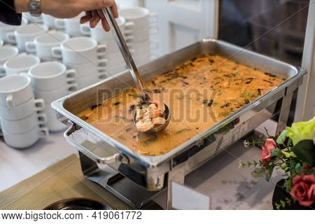 Food Buffet Catering Dining Eating Party Sharing Concept. Hand Hold River Prawn Spicy Soup On Buffet