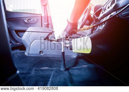 A Car Service Worker Cleans Interiror With A Special Foam Generator