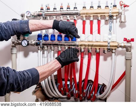 Pipefitter Install System Of Underfloor Heating System At Home