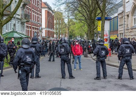 Hamburg, Germany - May 1, 2021: Left-wing Protester With Socialist, Communist Hammer And Sickle Hood