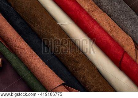 Artificial Leather Samples On A Cow Leather Background. Top View.