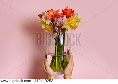 Spring Flowers In A Vase On A Pink Background