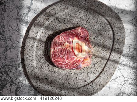 Raw Ossobuco On Stone Gray Plate, Sunlight Immitation