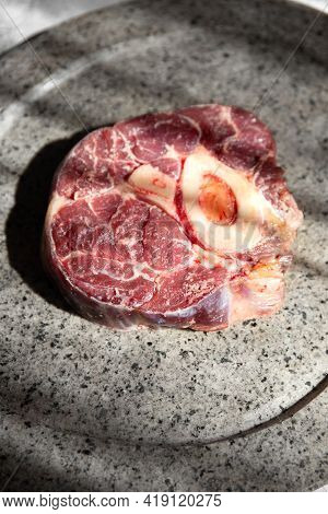 Raw Ossobuco On Stone Gray Plate, Sunlight Immitation