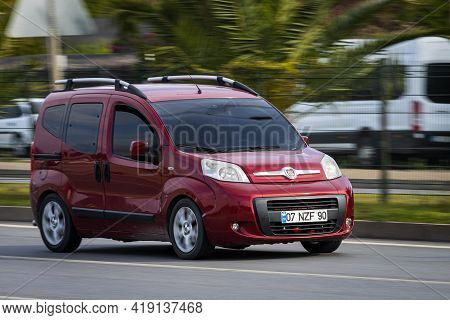 Alanya, Turkey - April 16 2021:  Red Fiat Duplo  Is Driving Fast On The Street On A Warm Summer Day 