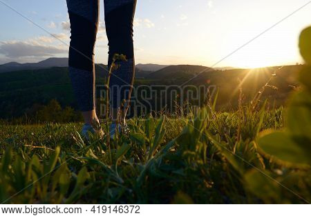 Woman in nature in sunset. People in nature. Woman walking in meadow in nature in sunset. people. Happy people. Woman legs in nature in sunset. Woman walking in meadow in sunset. Woman. People. Sunset. Nature.