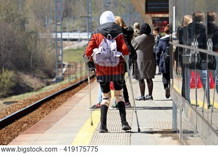 Orthosis For Legs, Woman With Crutches Standing On Railway Station In Crowd Op People. Orthopedic De