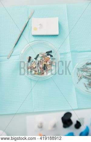 Prophy Cups Tray, Dental Spatula And Cement Lying On Table