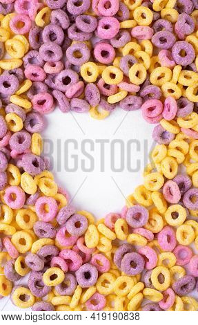 Multicolored Breakfast Cereal Loops Framing Heart Shaped Copy Space On White
