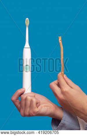 A Guy In A White Coat Holds A White Electric Toothbrush And Miswak (sivak), Arak Tree, Persian Salva