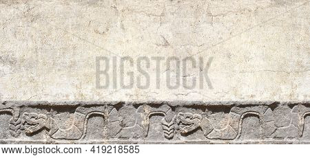 Grunge background with stone wall texture and bas-relief carving of a snake. Horizontal banner with copy space for text. Mock up template