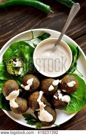 Falafel Balls. Deep Fried Balls From Ground Chickpeas. Traditional Middle Eastern Food. Wooden Backg