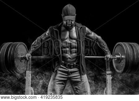 Muscular Bearded Man Stands Near The Barbell. Bodybuilding, Fitness, Powerlifting Concept.